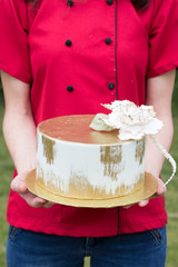 baker holding cake