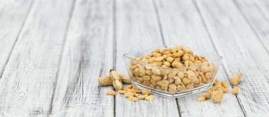 Roasted and salted Peanuts on vintage background