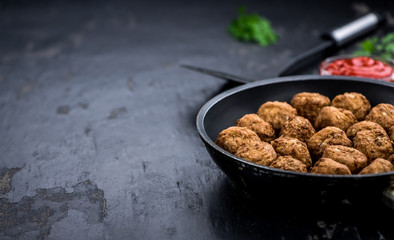 Fresh made Meatballs on a slate slab (close-up shot; selective focus)