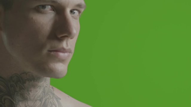 Handsome sexy young man stylish with tattoo on his neck, torso and hand - ultra close up - greenscreen Prores - cinematic lighting