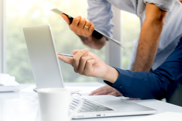 Top view desk of work table in office woth laptop computer , notebook , calculator and a cup of coffee for creative business work or marketing plan to success planning of company