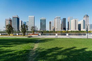Fototapeta na wymiar green lawn with city skyline background
