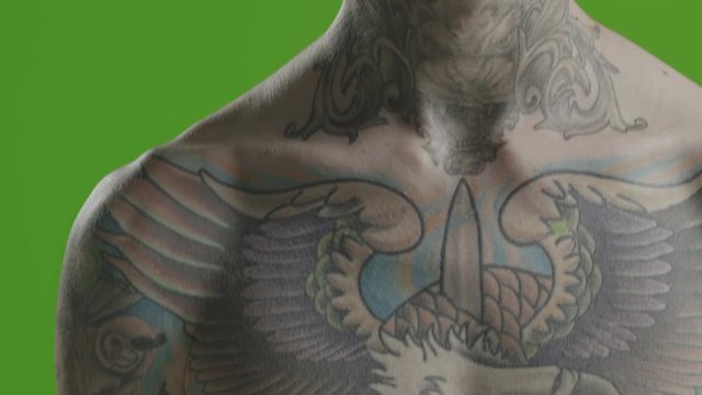 Handsome sexy young man stylish with tattoo on his neck, torso and hand - ultra close up body and face detail - greenscreen Prores - cinematic lighting