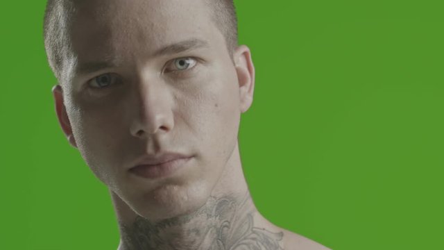 Handsome sexy young man stylish with tattoo on his neck, torso and hand - ultra close up - greenscreen Prores - cinematic lighting