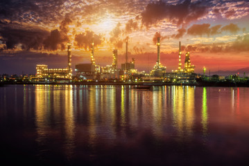 Fototapeta premium Oil and gas industry - refinery at Sunrise - factory - petrochemical plant with reflection over the river