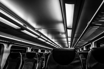 Fototapeta premium Dover, NJ USA - November 1, 2017: New double-decker NJ Transit train at night with empty seats, black and white