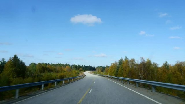 Autumn color road, Hyper lapse driving on route e75 full of different fall colors, from inari towards utsjoki, on a sunny autumn day, in Lapland, Finland