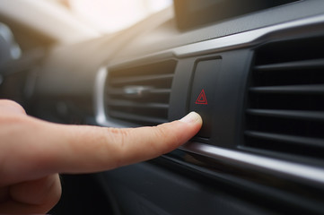 Close up Press Emergency button in the car.