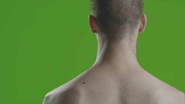 Handsome sexy young man stylish with tattoo on his neck, torso and hand - middle shot portrait studio - greenscreen Prores - cinematic lighting