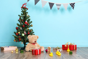 Christmas tree, flag and Christmas decorations with toy teddy bear on blue background, Happy New Year on 2017 with copy space