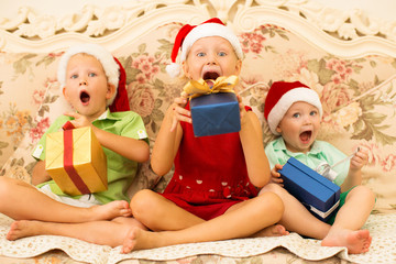 Excited funny children in anticipation of gifts