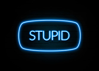 Stupid  - colorful Neon Sign on brickwall