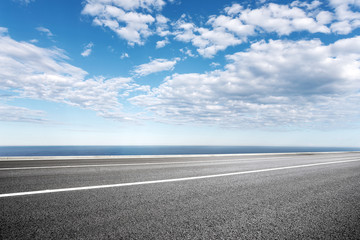 Fototapeta premium empty asphalt road with blue sea in blue sky
