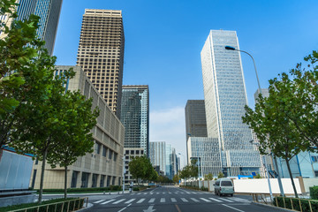 Fototapeta na wymiar city road through modern buildings in beijing.