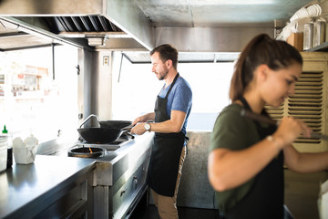 Workers cooking food in a truck