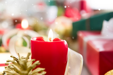 Red candle with Christmas gifts
