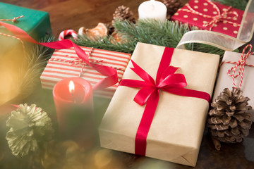 Group of colorful Christmas gift boxes with candles and decorating items in the table at home