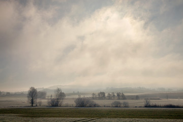 Fototapeta na wymiar A view of frosted field in winter day in Lorraine, France