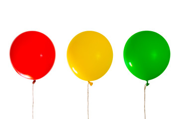 three helium balloons with colors of  traffic lights: red, yellow, green. Isolated
