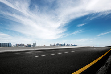 Fototapeta premium empty asphalt road with modern bridge and buildings