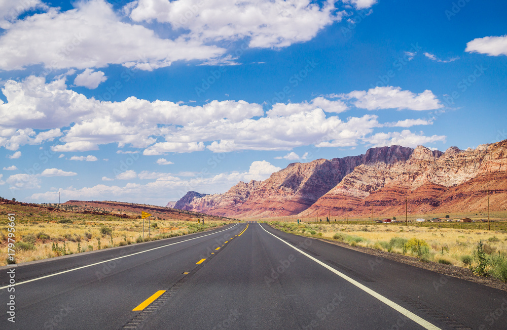 Poster Picturesque road in Arizona. red stone cliffs and blue sky