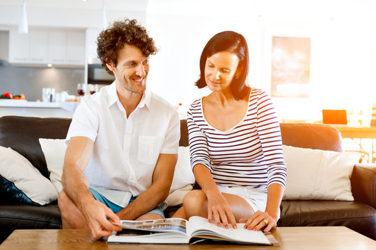 Couple at home with a book