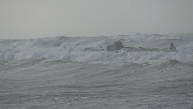 Waves rolling on the beach is a stormy day, winter mediterranean sea. Focene, Lazio, Italy. 4k
