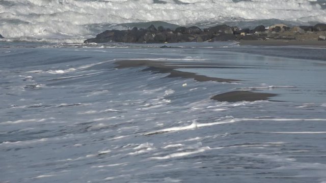 Waves rolling on the beach is a stormy day, winter mediterranean sea. Focene, Lazio, Italy. 4k