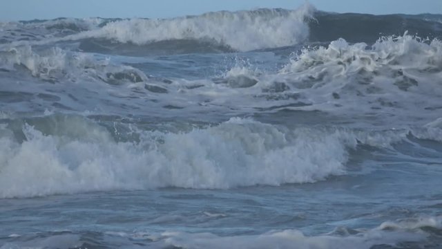 Waves rolling on the beach is a stormy day, winter mediterranean sea. Focene, Lazio, Italy. 4k