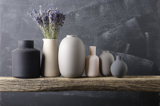 Various vases on wooden shelf
