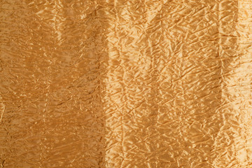 texture of a relief fabric of gold color