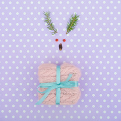 Reindeer face made of Christmas decoration and pine branches. Minimal christmas concept.