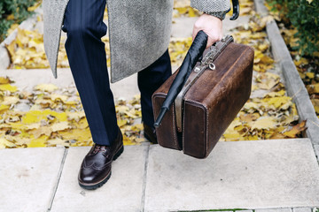 Men autumn fashion. Man in stylish shoes and a white coat