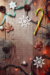Beautiful Christmas background with gingerbreads, sweets and gift on wooden background. Merry Christmas greeting card