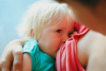 mother breastfeeding little baby daughter