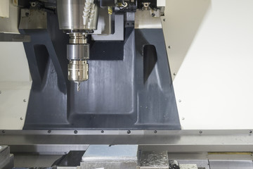 The CNC milling machine cutting cutting the raw material with the small ball-end mill tool .Hi-precision CNC machining concept.