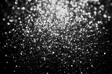 Black glitter sparkle background. Black friday shiny pattern with sequins. Christmas glamour luxury...