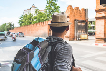 Naklejka premium Independent Asian man tourist backpacker at Tha Phae Gate Chiang Mai Thailand,