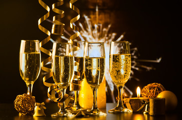 champagne glasses against holiday lights ready for New Year's eve party