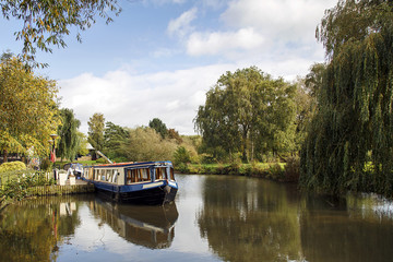 Narrow boat moored on the Avon canal awaiting tourists to cruise down the river through Stratford upon Avon