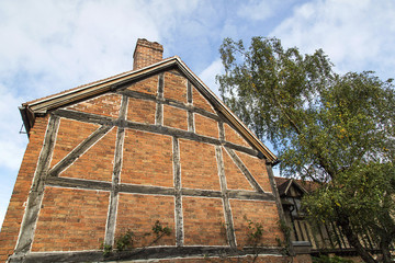 Gable end wall of a traditionally built Elizabethan half timbered, red brick house in Stratford upon Avon, England