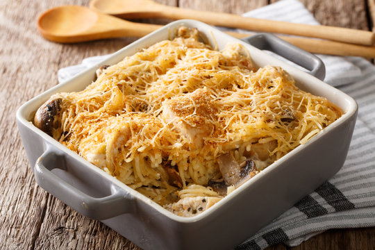 American tetrazzini with spaghetti, mushrooms, cheese, chicken close-up in baking dish. Horizontal