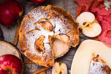 Sliced apple pie on a wooden table. Top view