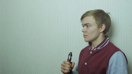 Young man smoking electronic cigarette. Young Man Using Vapourizer As Smoking Alternative