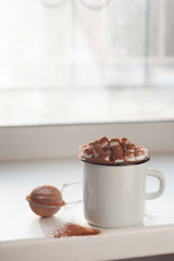 Enamel cup of hot cocoa with marshmallows, minimalizm, morning still life. Perfect winter time treat.