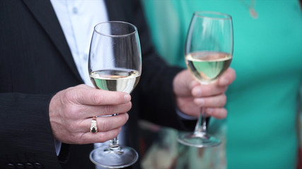 Senior man is standing with a glass of champagne. Old man with glasses of champagne