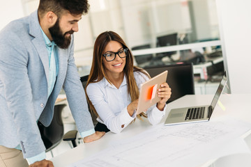 Portrait of young architects working in office