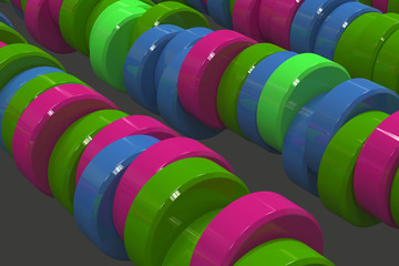 Pattern of blue, red and green cylinder tablets on black background