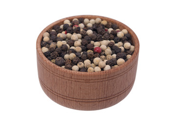 set of peppercorns in a wooden cup, on a white background