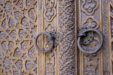 An old wood door with metal handle. Details of Muslim architecture.